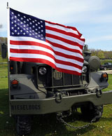 photo:  Soldier and family on small vehicle 
